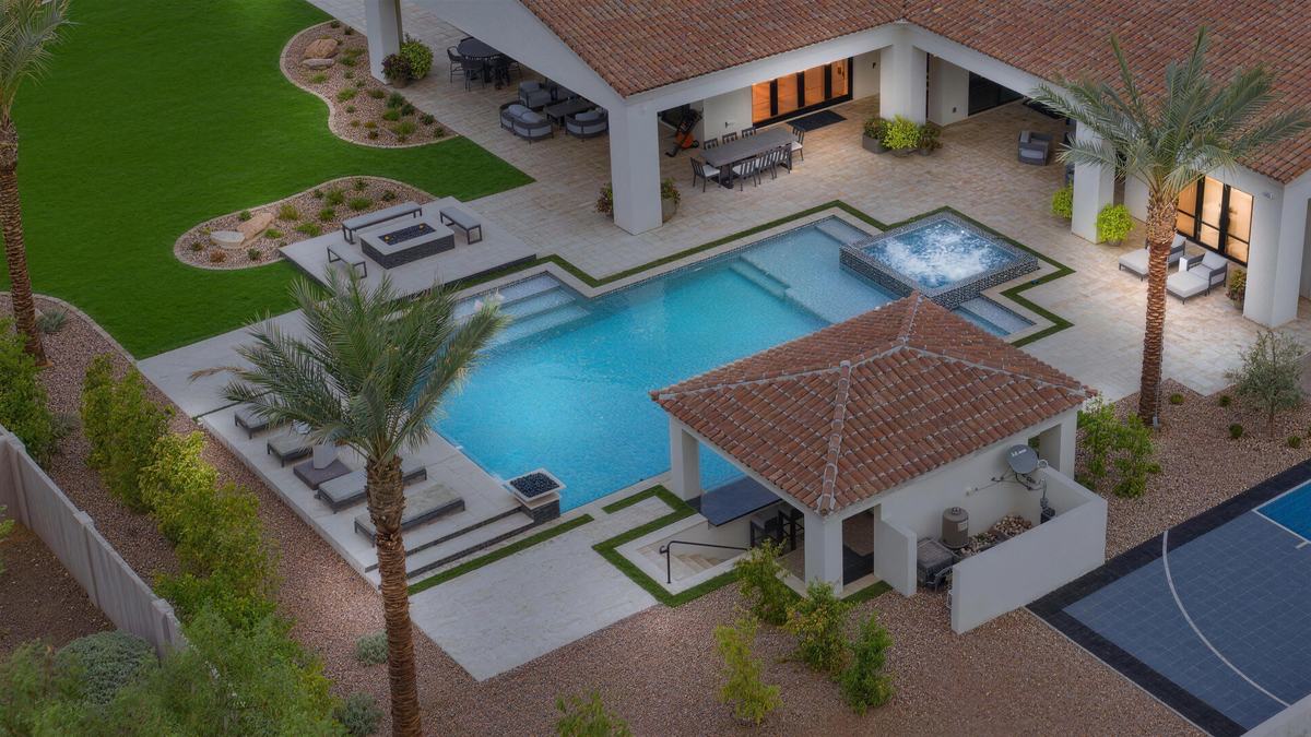 Aerial view of a No Limit custom pool with spa, fire feature, turf inlays and a tiled casita in the East Valley