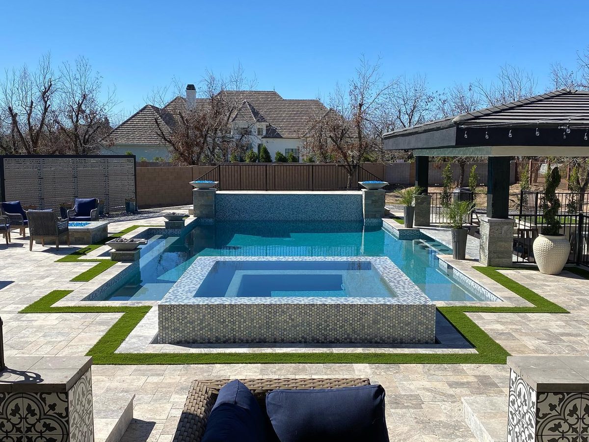 Spillover spa in hex tile with fire bowls and gazebo