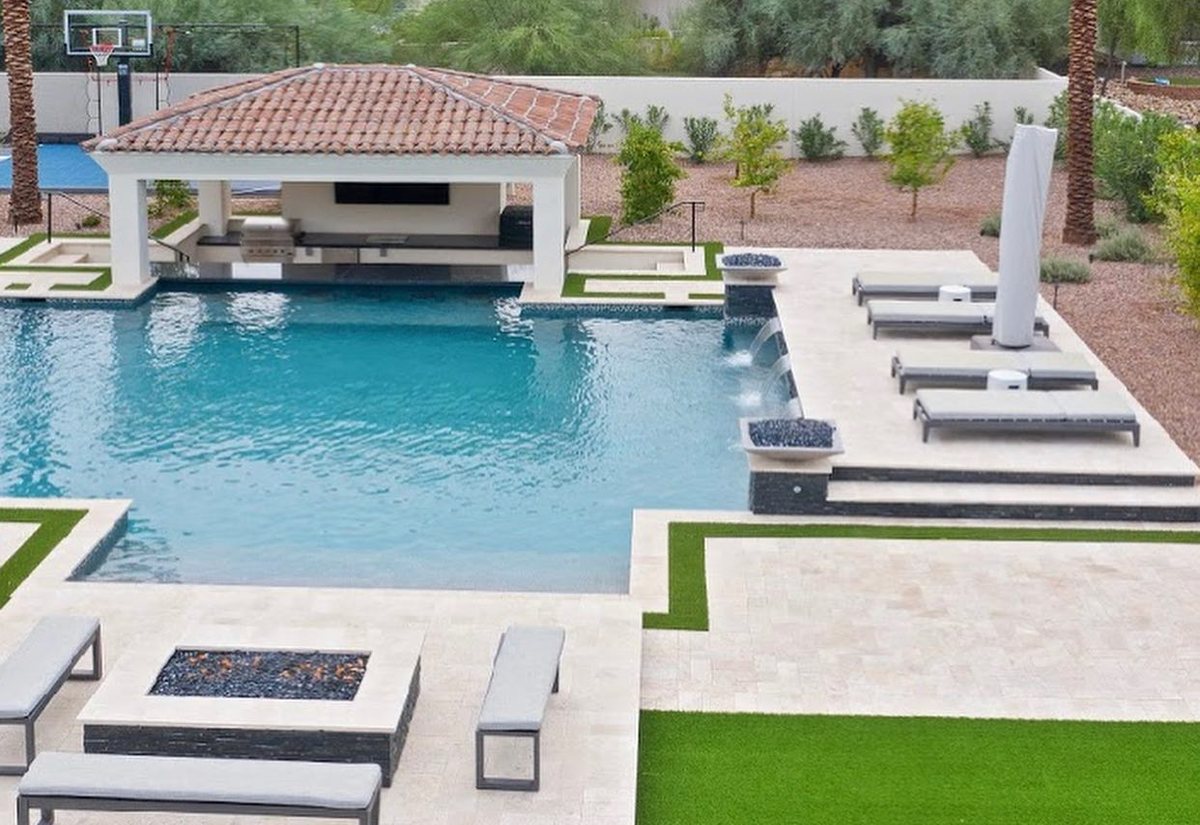 Ramada with outdoor kitchen and TV, loungers, fire pit and pool