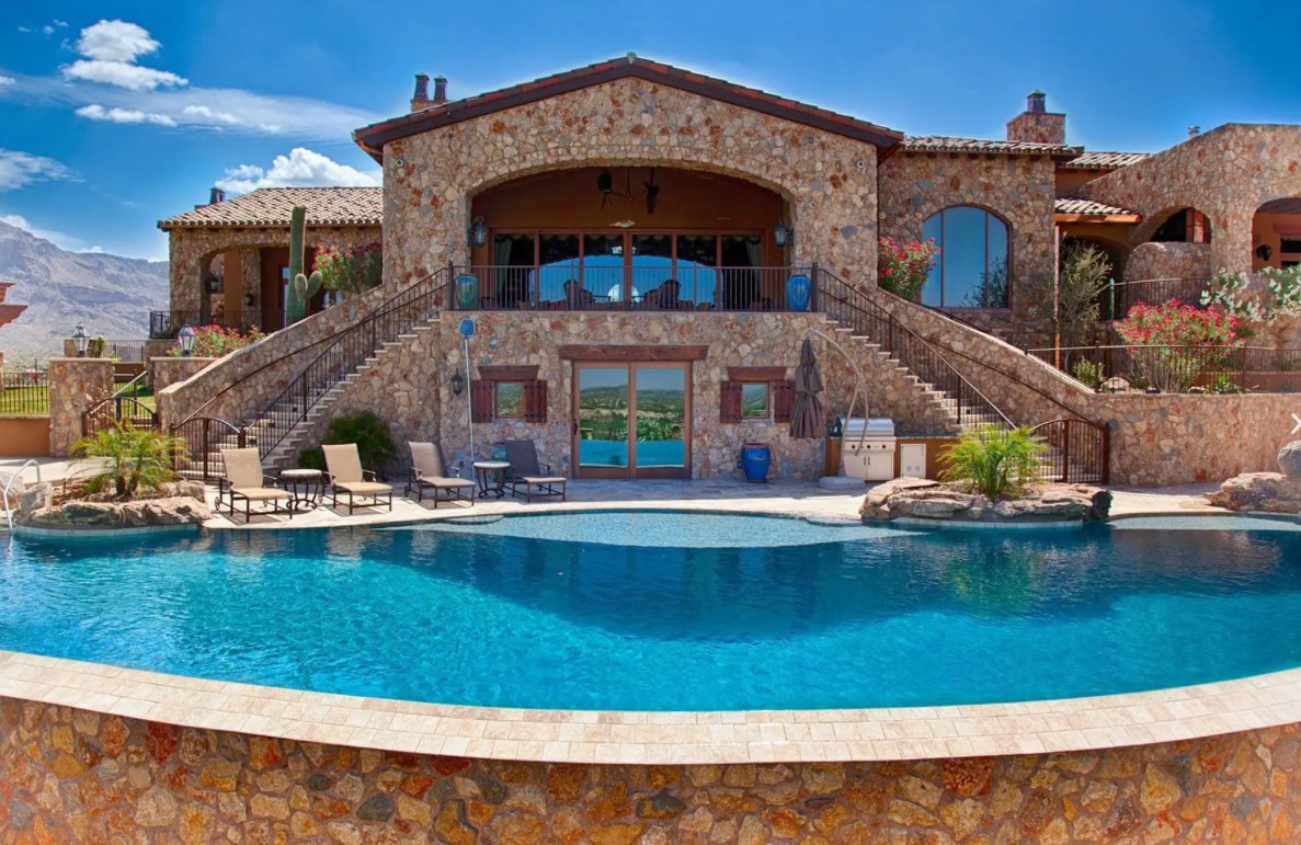 Hillside stone estate with pool and raised spa