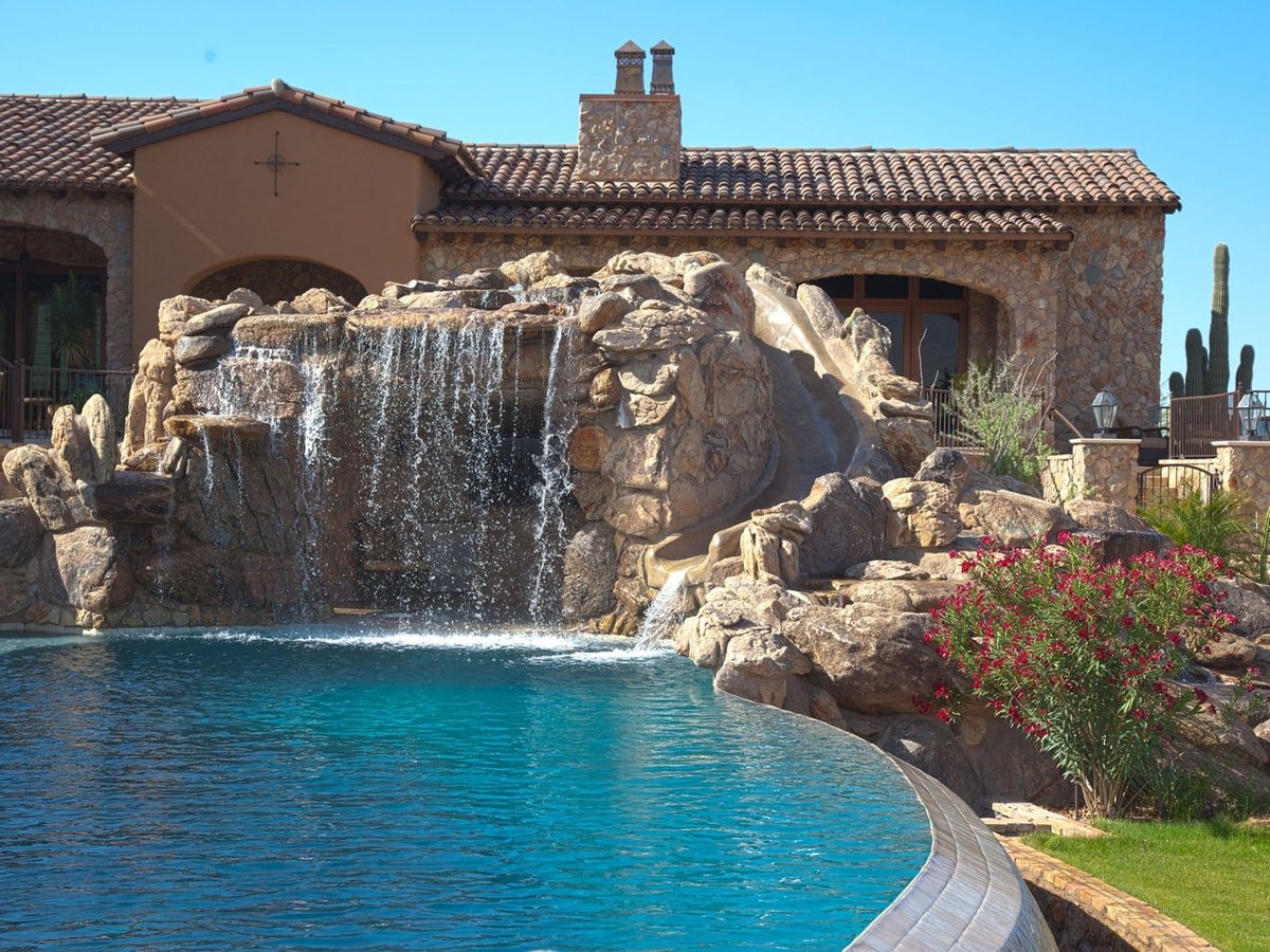 Skyline project: rock grotto waterfall and slide with the stone estate behind