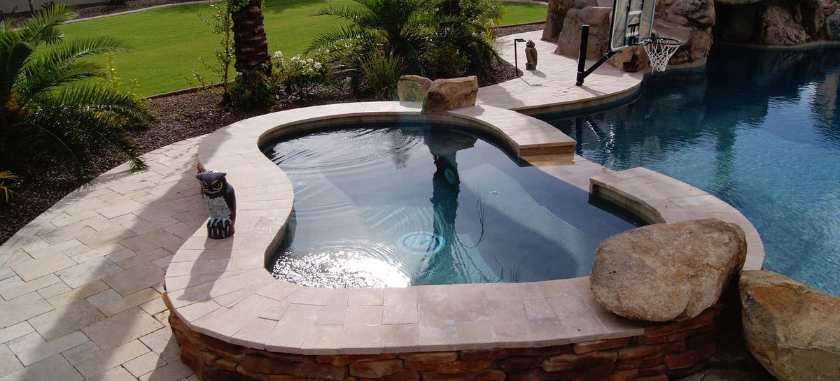 Raised stone spa and rock waterfall built by No Limit